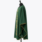 Side view of the green chasuble showing the gold piped hem and the full gothic drape over the arm