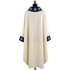 Plain ivory back of the chasuble showing the blue velvet collar and cuff bands set with gold fleur-de-lys