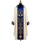 Front of an ivory chasuble with a royal blue velvet orphrey embroidered with a crowned Marian M, white lilies, a flowering vine and a gold fleur-de-lys
