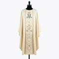 Front of an ivory chasuble embroidered tone on tone with a crowned blue Marian monogram, gold stars, white lilies and fleur-de-lys