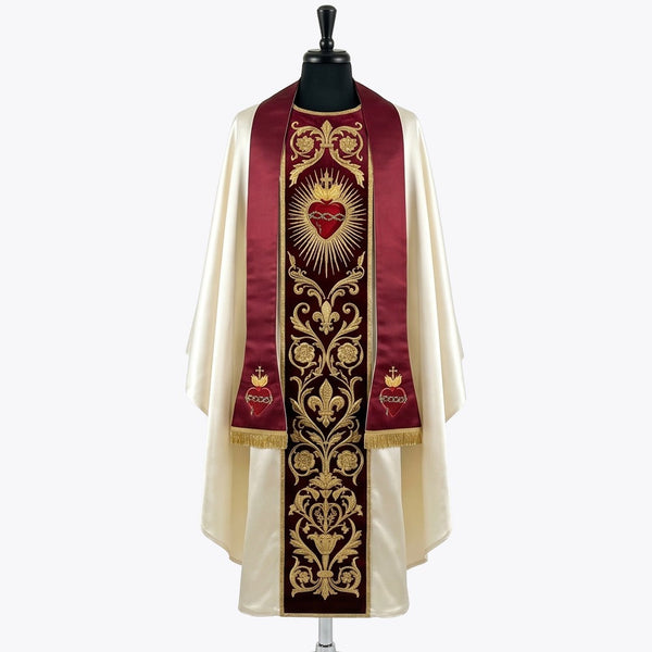 Front of an ivory satin chasuble with a red velvet orphrey embroidered in gold with the Sacred Heart of Jesus, shown with a matching red stole