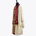 Side view of the ivory satin chasuble showing the red velvet orphrey and the fringed matching stole