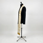 Side view of the ivory ordination stole showing gold grapevine embroidery and bullion fringe