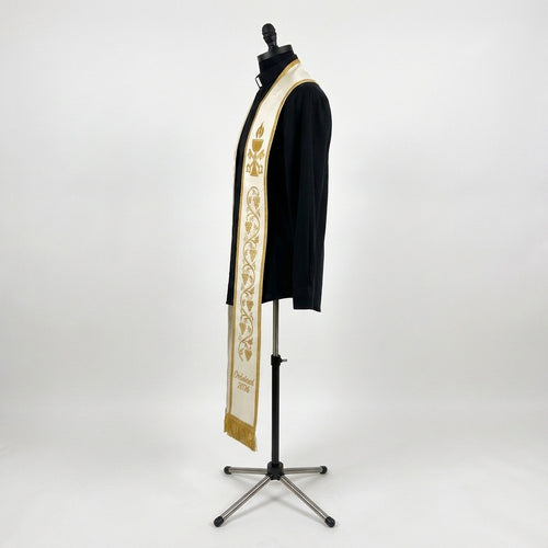 Side view of the ivory ordination stole showing gold grapevine embroidery and bullion fringe