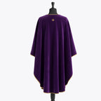 Plain violet back of the chasuble with a small gold fleur-de-lys at the neck and gold piping along the hem