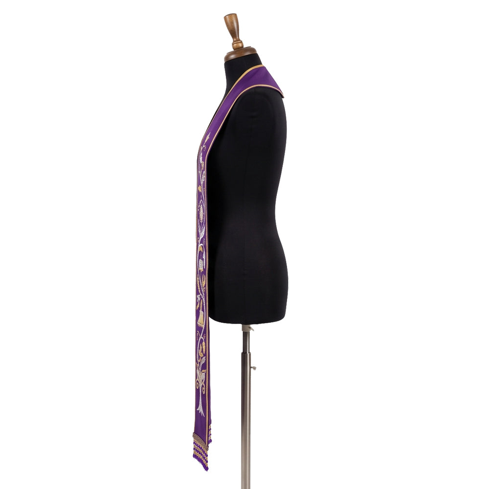 Side view of the violet vine stole on a dress form, showing the gold tree trunk motif near the fringed hem.