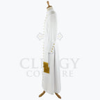 Side view of the white cassock robe showing the gold cuff detail and the tassel hanging against the skirt.
