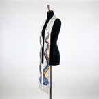 Close side view of the white baptism stole's dove and rainbow embroidery with small water droplets in relief